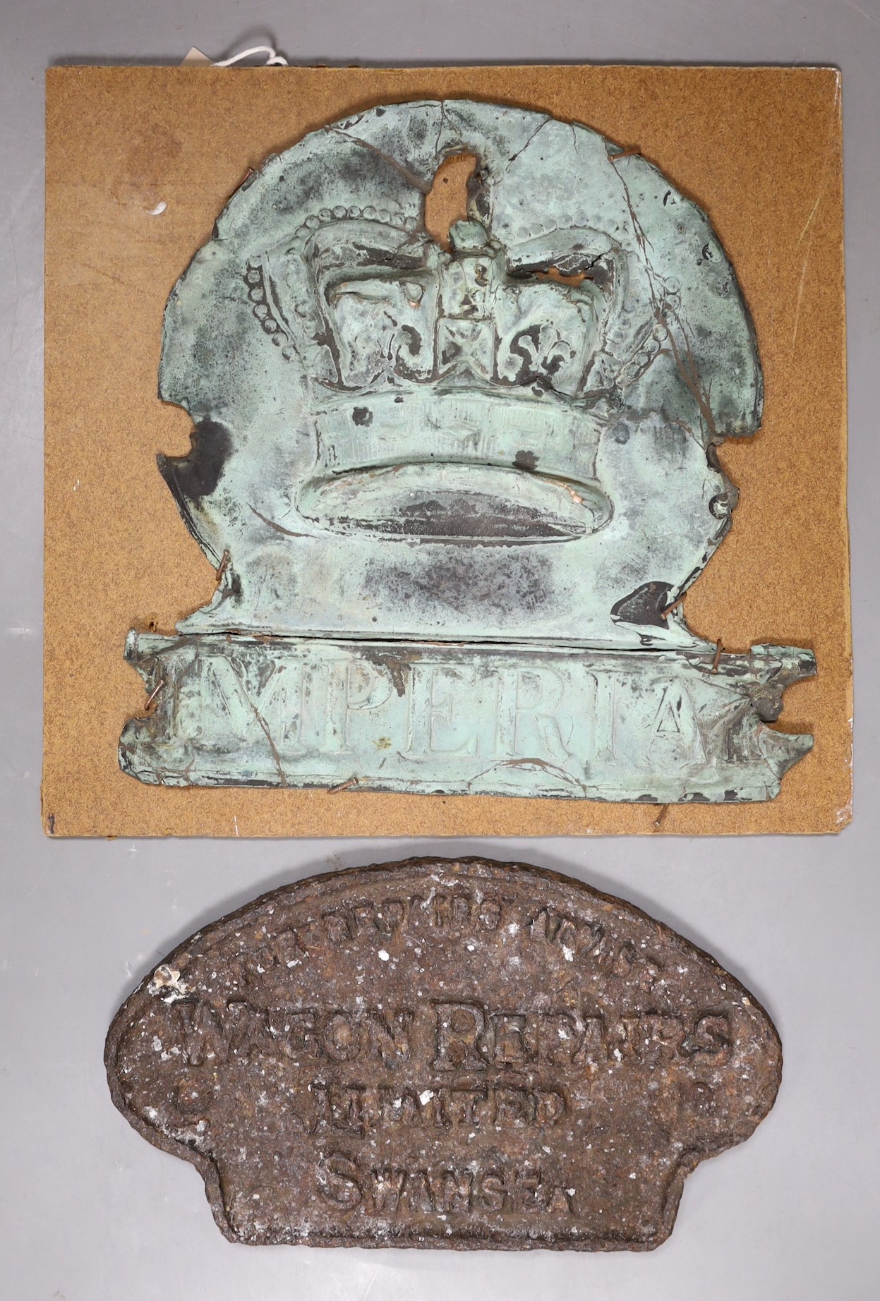 A late 18th century copper Imperial firemark and a cast iron locomotive plaque, Wagon Repairs Ltd, Swansea largest 21cms high